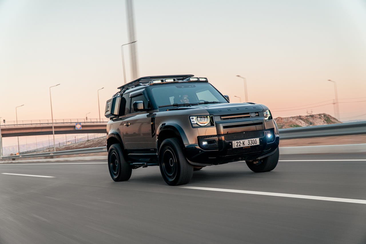 services-01 Dynamic shot of a Land Rover Defender speeding on a highway in Erbil, Iraq at sunset.